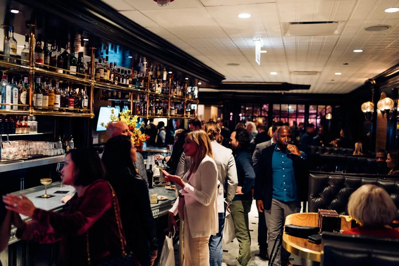 Guests gathered around the bar at Brass Tack