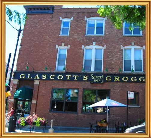 The brick exterior and green awning of Glascott’s Groggery