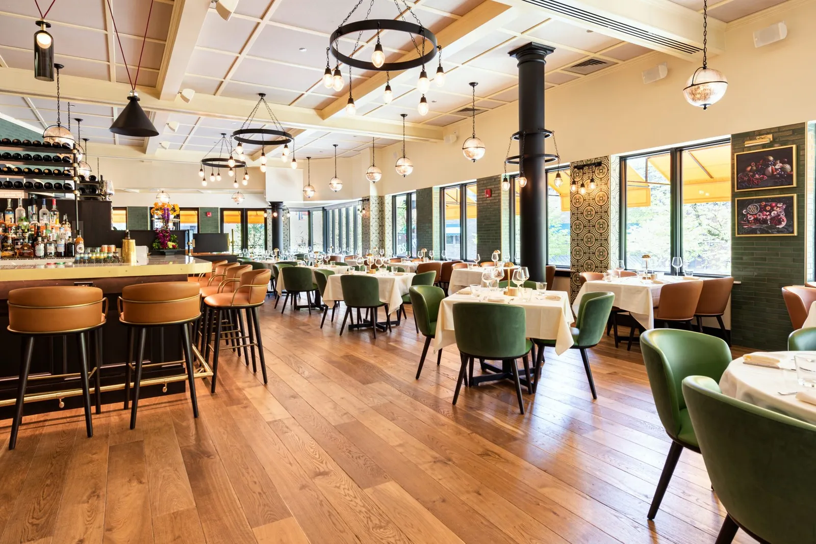 The Bellevue dining room with green seating and a long bar