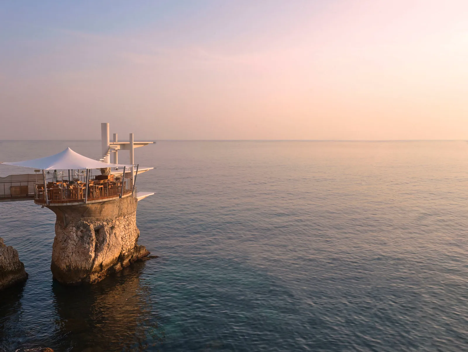 Le Plongeoir seen from shore, with its rock, terrace and diving boards above the sea