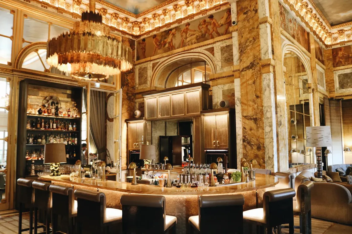 Gilded walls, chandeliers and a curved bar at Les Ambassadeurs