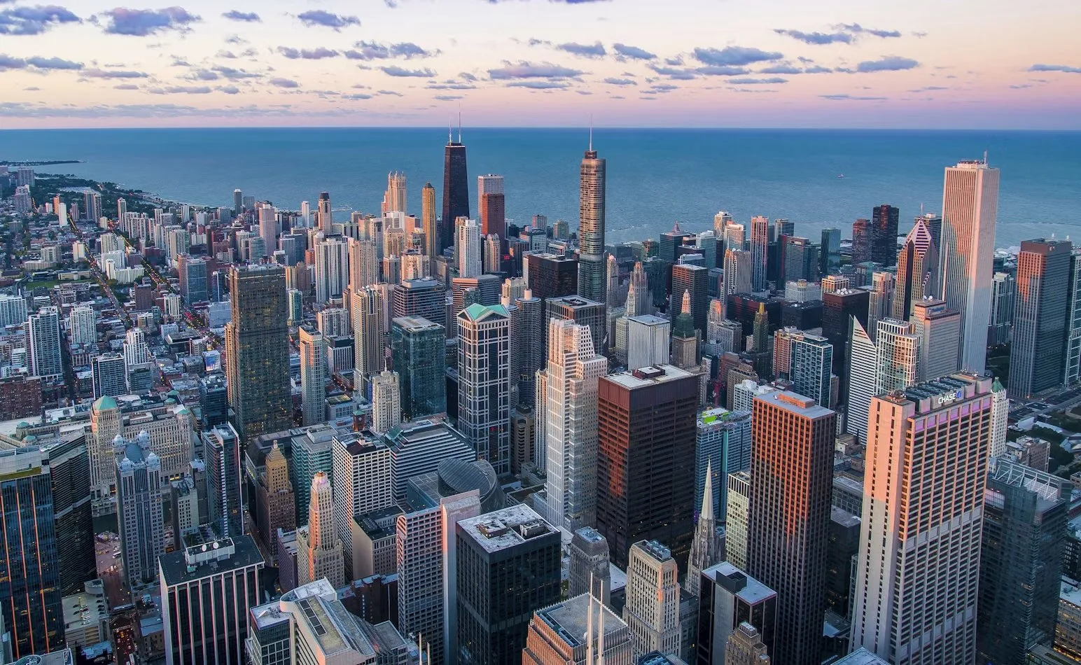 Chicago towers overlooking Lake Michigan beneath an evening sky