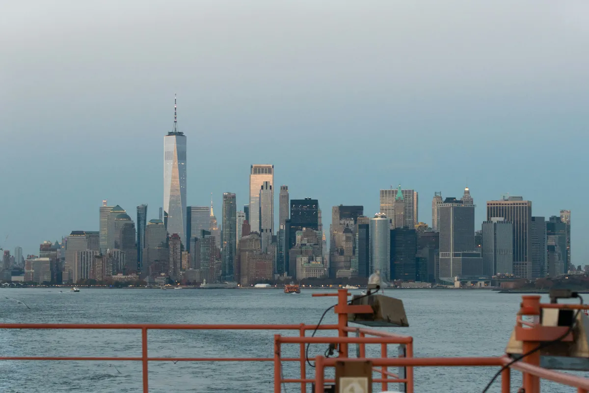 Manhattan skyline across the water at dusk